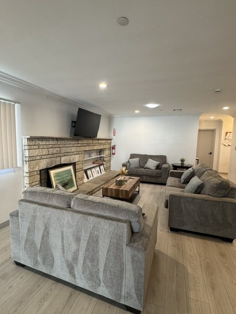 Seating area around the fireplace, viewed from behind the sofa