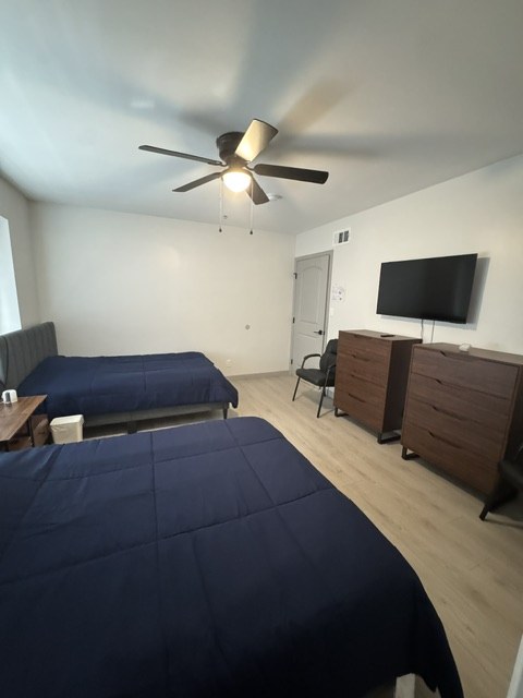 A resident bedroom at HavenBloom with navy bedding